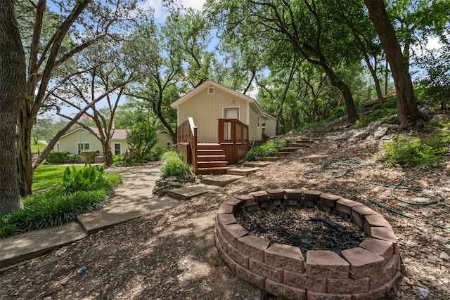 2311 Cedar Cir, Granbury, TX 76048 - view of yard featuring an outdoor fire pit and an outdoor structure