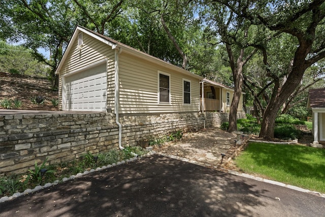 2311 Cedar Cir, Granbury, TX 76048 - view of side of property featuring a garage
