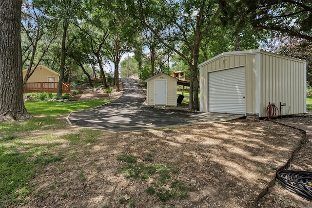 2311 Cedar Cir, Granbury, TX 76048 - detached garage with a storage unit and dirt driveway