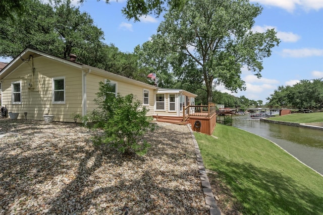 2311 Cedar Cir, Granbury, TX 76048 - rear view of house featuring a yard and a deck with water view