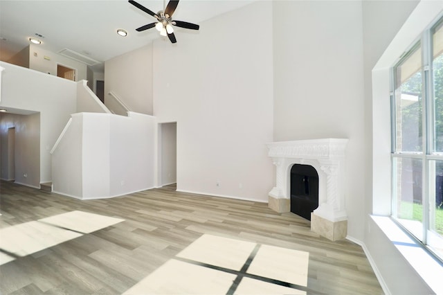 2625 Cumberland Trl, Balch Springs, TX 75181 - unfurnished living room featuring baseboards, light wood-style flooring, and a high ceiling