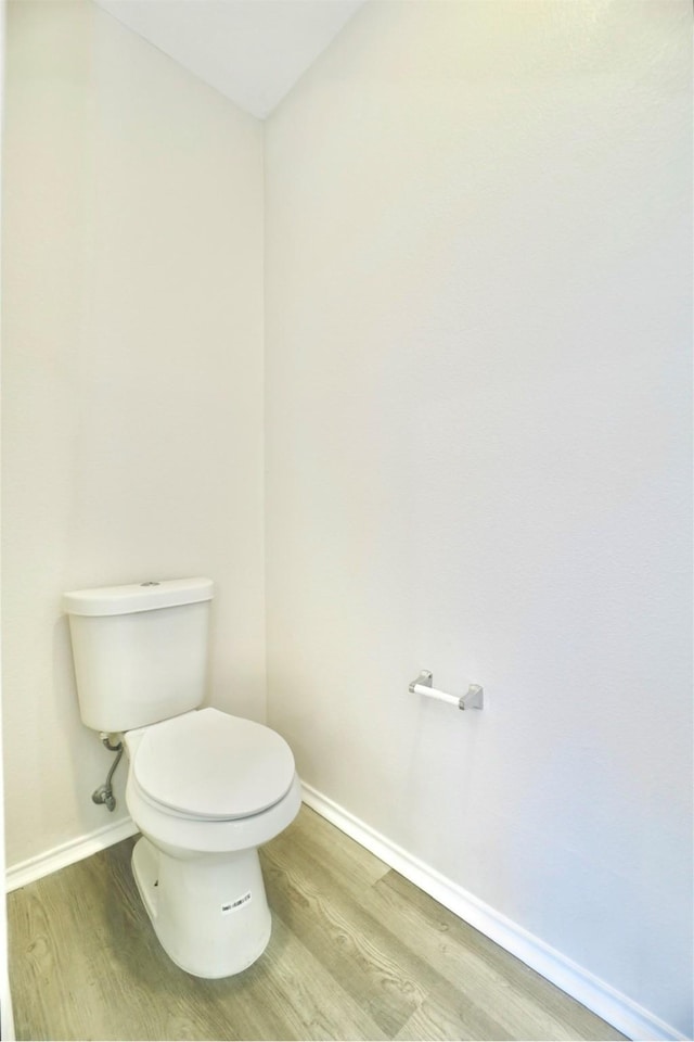 2625 Cumberland Trl, Balch Springs, TX 75181 - bathroom featuring baseboards, wood finished floors, and toilet