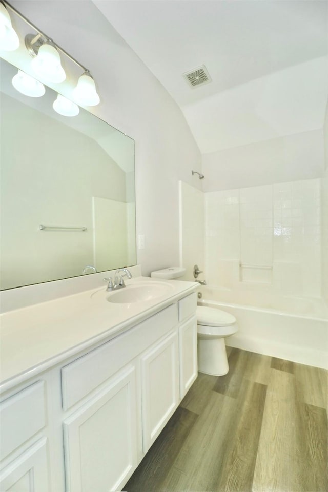 2625 Cumberland Trl, Balch Springs, TX 75181 - full bathroom with visible vents, vanity, toilet, wood finished floors, and vaulted ceiling