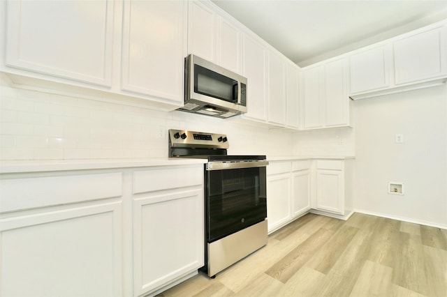 2625 Cumberland Trl, Balch Springs, TX 75181 - kitchen with light wood-type flooring, light countertops, white cabinets, and stainless steel appliances