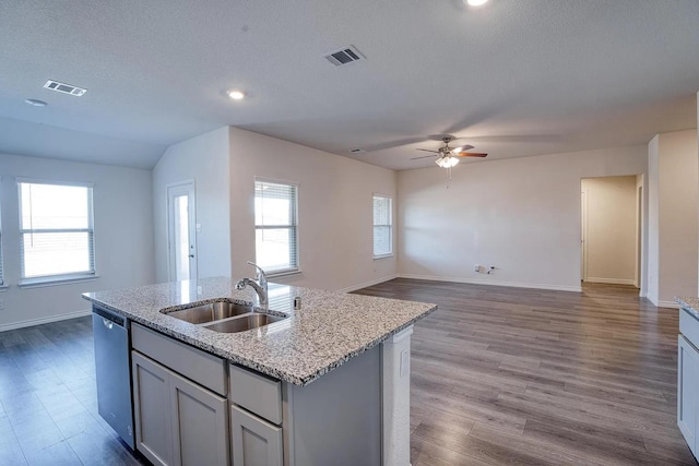 kitchen with stainless steel dishwasher, ceiling fan, visible vents, and a sink
