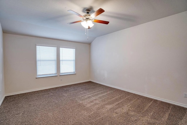 empty room with a ceiling fan, baseboards, and dark carpet