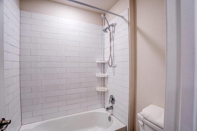 bathroom featuring shower / bathtub combination and toilet