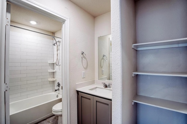full bathroom featuring vanity, a textured wall, toilet, and shower / washtub combination