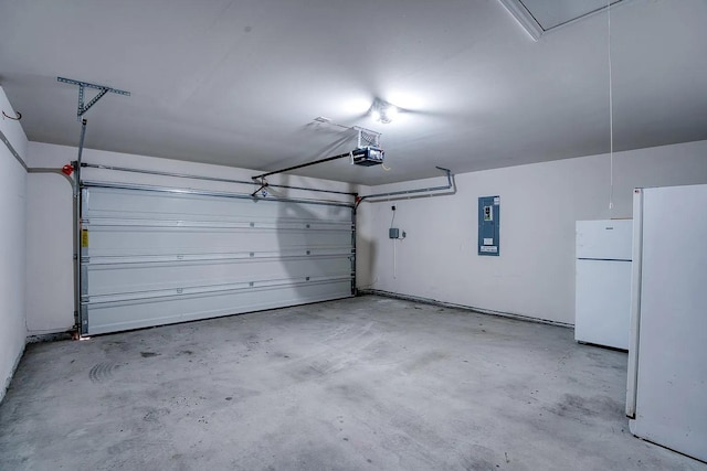 garage with freestanding refrigerator, a garage door opener, and electric panel