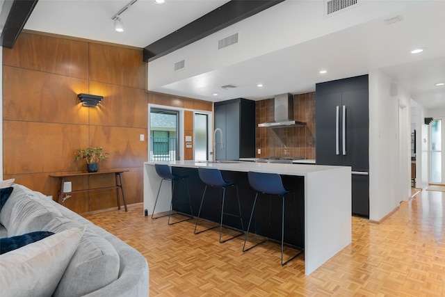 kitchen featuring a sink, light countertops, built in refrigerator, visible vents, and modern cabinets