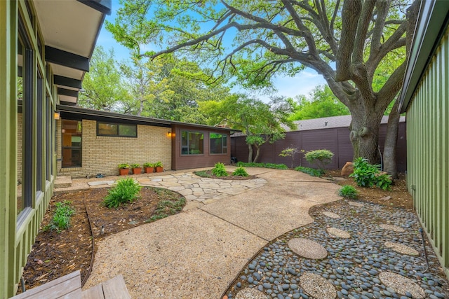 view of yard with a fenced backyard and a patio
