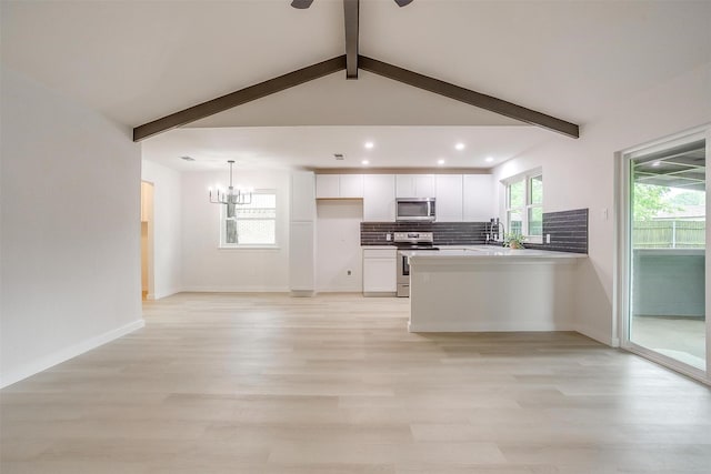 kitchen featuring decorative backsplash, appliances with stainless steel finishes, white cabinets, recessed lighting, and light wood-style flooring