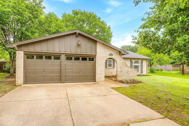 single story home with board and batten siding, a garage, brick siding, a front lawn, and concrete driveway