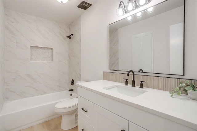 bathroom featuring toilet, visible vents, bathing tub / shower combination, and vanity