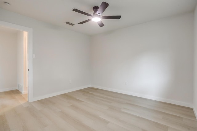 empty room with ceiling fan, visible vents, baseboards, and light wood-type flooring