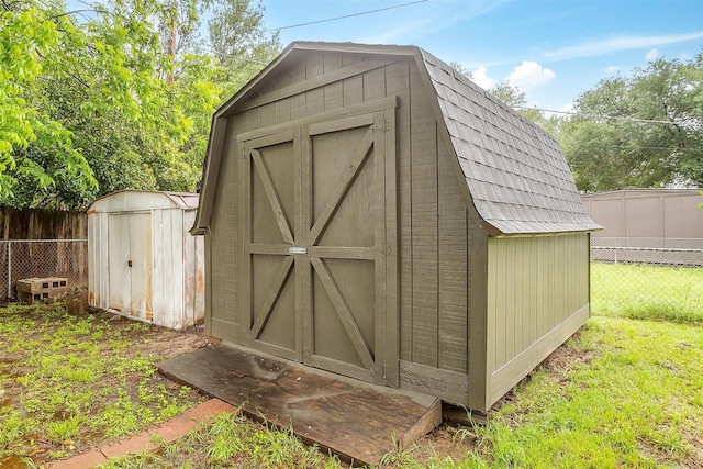 view of shed featuring fence
