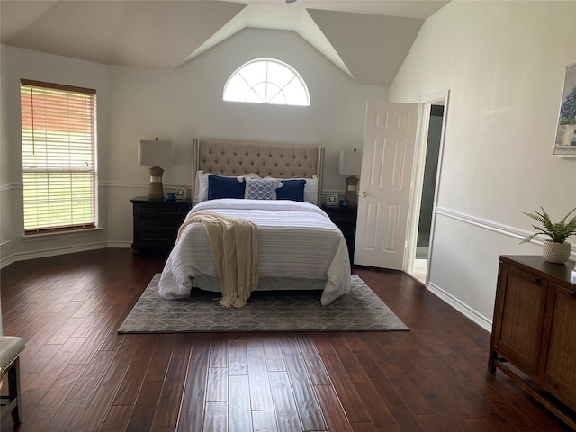 bedroom with baseboards, vaulted ceiling, and dark wood finished floors
