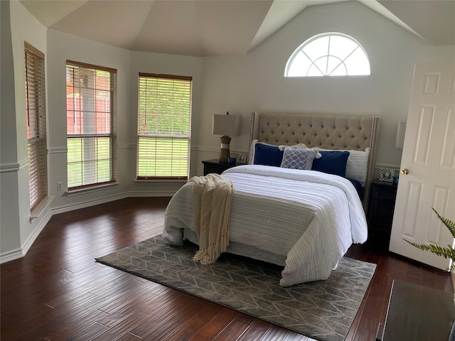 bedroom featuring dark wood-style flooring, baseboards, and lofted ceiling