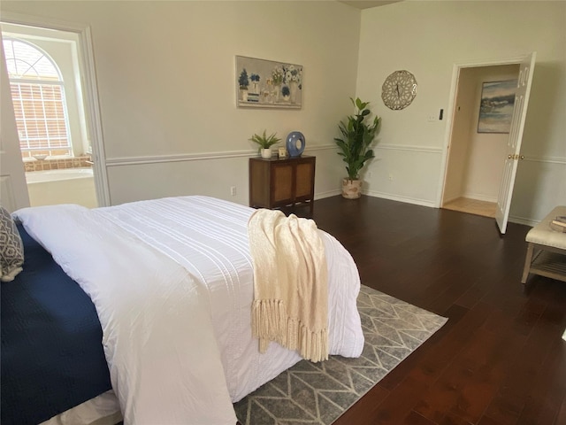 bedroom featuring baseboards and wood finished floors