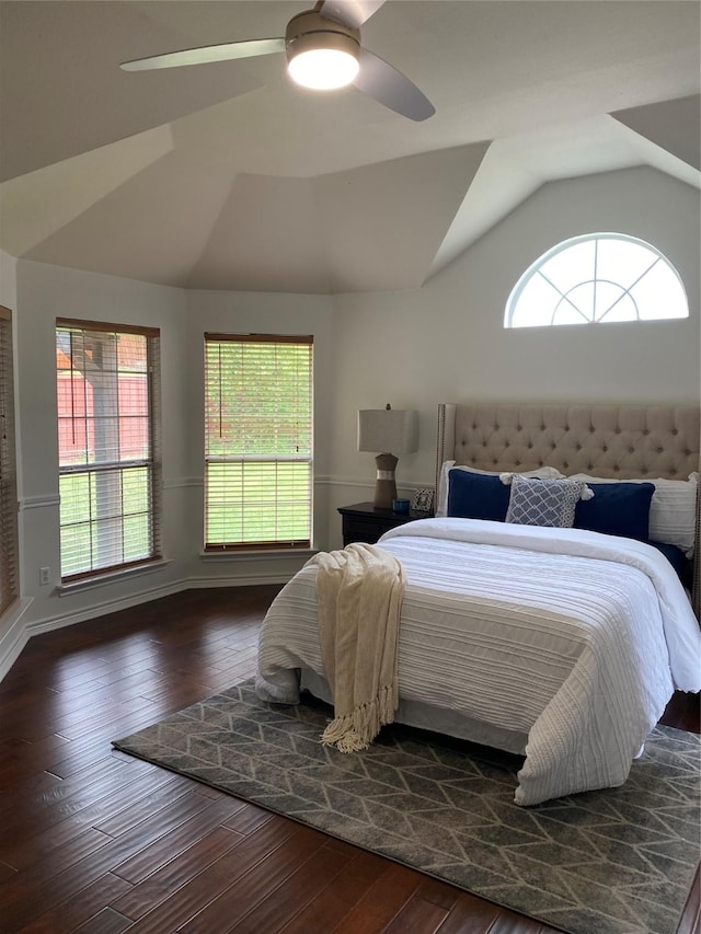bedroom featuring a ceiling fan, baseboards, dark wood-style floors, and lofted ceiling