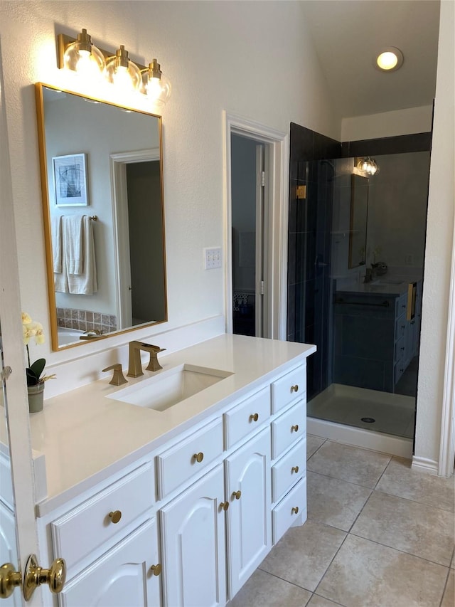 full bath featuring lofted ceiling, a shower stall, tile patterned flooring, and vanity