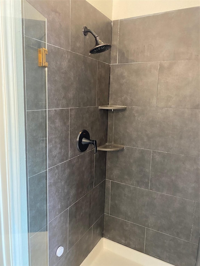 bathroom with tiled shower