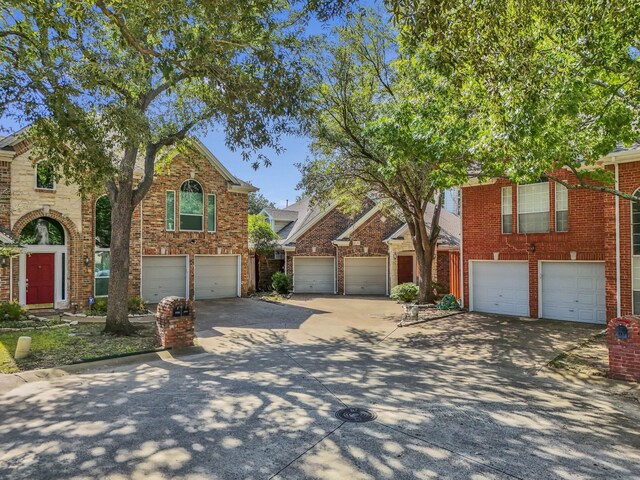 2630 Lakeforest Ct, Dallas, TX 75214 - view of front of property with concrete driveway, a garage, and brick siding