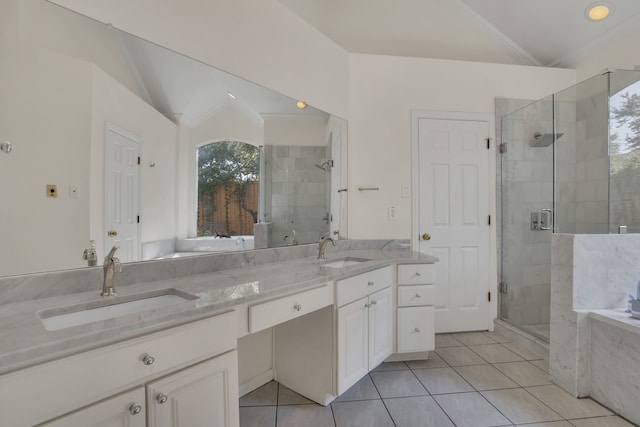 2630 Lakeforest Ct, Dallas, TX 75214 - bathroom featuring tile patterned flooring, a tub with marble appearance, a stall shower, double vanity, and lofted ceiling