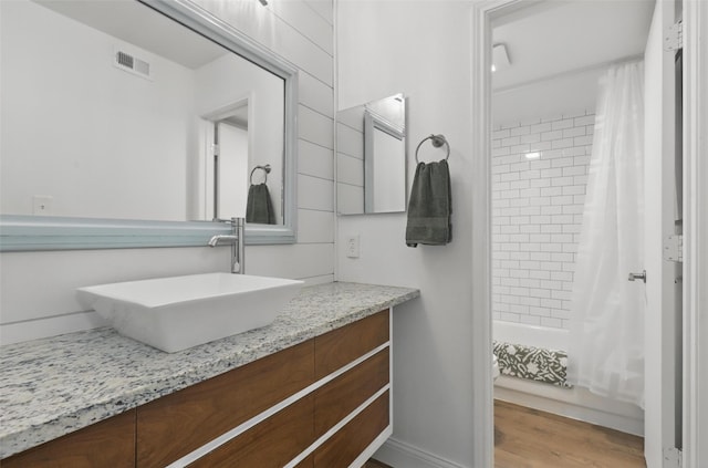 3244 Donnelly Cir Unit 1110, Fort Worth, TX 76107 - bathroom with vanity, shower / tub combo with curtain, and wood finished floors