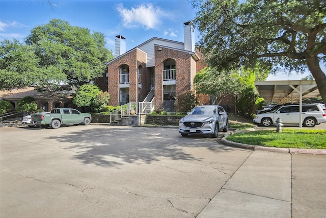 3244 Donnelly Cir Unit 1110, Fort Worth, TX 76107 - view of building exterior featuring uncovered parking and stairway