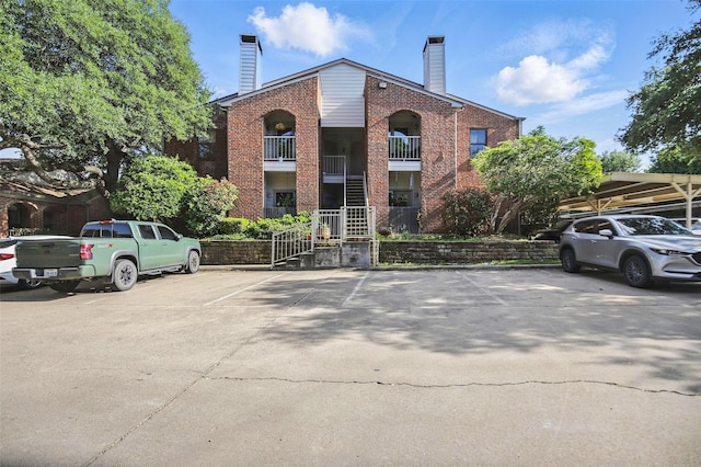 view of property with uncovered parking