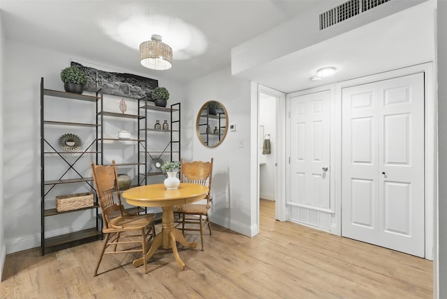 dining room with visible vents, baseboards, and wood finished floors