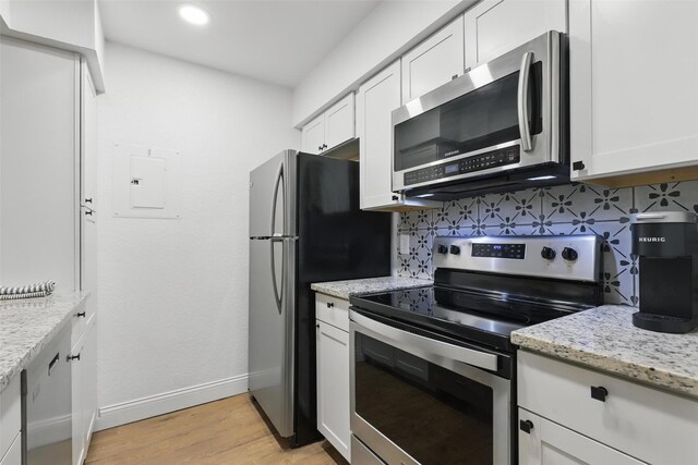 3244 Donnelly Cir Unit 1110, Fort Worth, TX 76107 - kitchen featuring appliances with stainless steel finishes, tasteful backsplash, baseboards, white cabinets, and recessed lighting