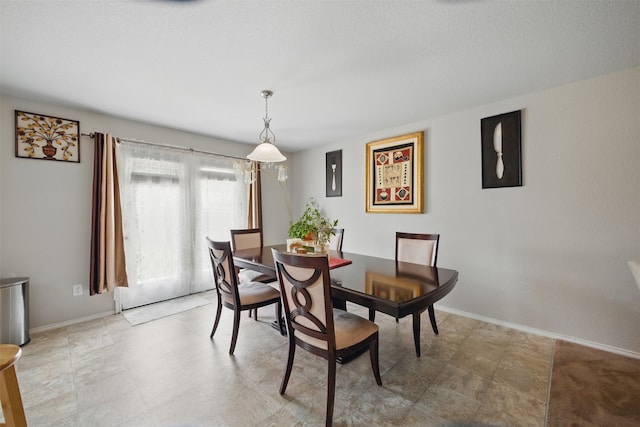dining space featuring baseboards