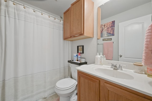 bathroom featuring vanity, toilet, and curtained shower