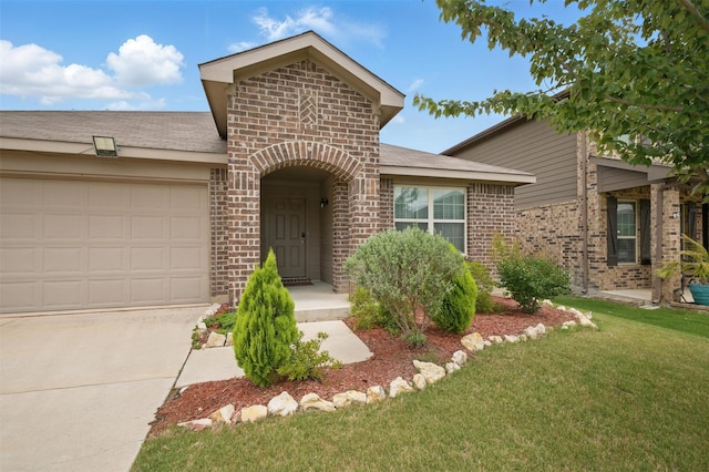 view of front of home featuring a garage, a front lawn, brick siding, a shingled roof, and concrete driveway