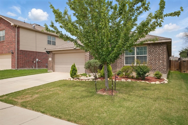 view of front of house with brick siding, driveway, fence, and a front yard