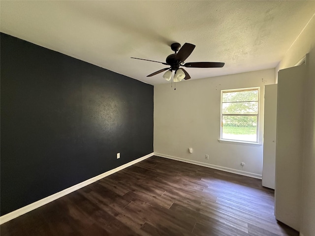 290 Dickard St, Hawkins, TX 75765 - empty room with baseboards, a ceiling fan, dark wood-style flooring, and a textured ceiling