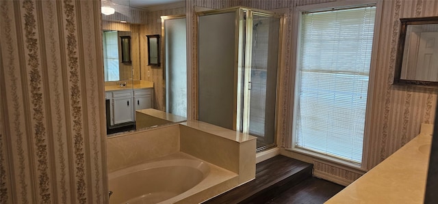 2 Woodfern Ln, Haughton, LA 71037 - bathroom featuring a garden tub, a stall shower, wood finished floors, vanity, and wallpapered walls