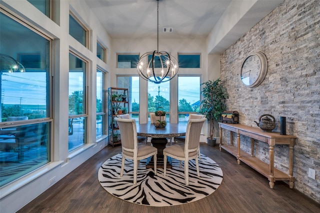 dining space featuring dark wood-style flooring, a chandelier, and a wealth of natural light