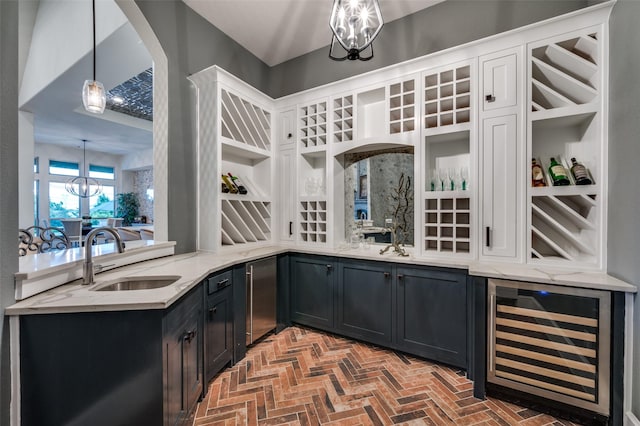bar featuring beverage cooler, indoor wet bar, brick floor, a sink, and decorative light fixtures