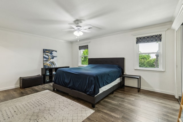 bedroom featuring baseboards, ornamental molding, ceiling fan, and wood finished floors