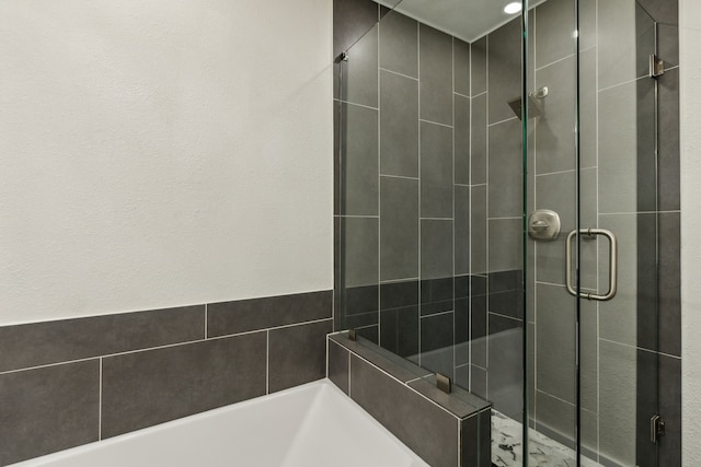 full bath featuring a bath and a stall shower