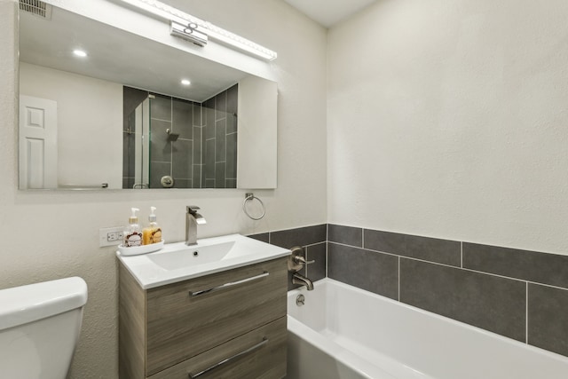 bathroom featuring a bath, visible vents, vanity, toilet, and tiled shower