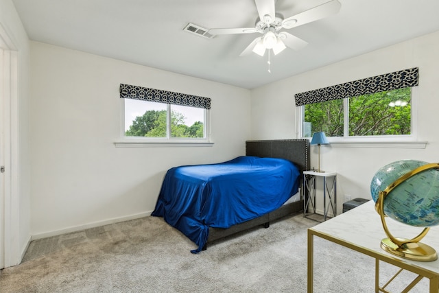 bedroom with carpet floors, a ceiling fan, baseboards, and visible vents