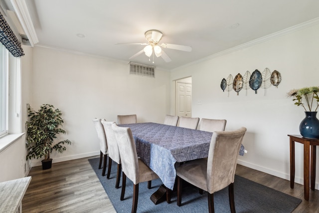 dining space featuring visible vents, ornamental molding, wood finished floors, baseboards, and ceiling fan