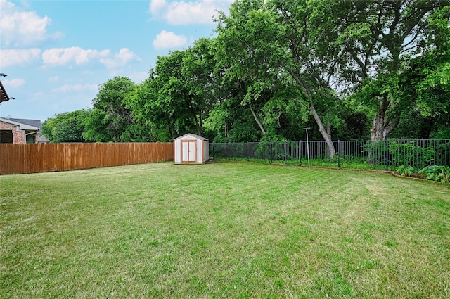 view of yard with a fenced backyard, an outbuilding, and a shed