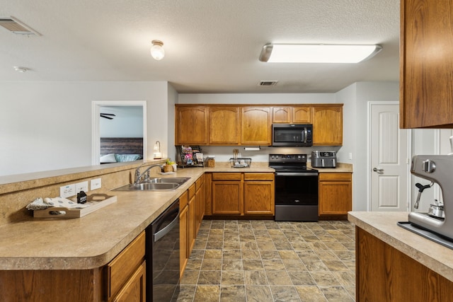 2041 Lake Trail Dr, Heartland, TX 75126 - kitchen with black / electric stove, brown cabinetry, visible vents, dishwasher, and a sink