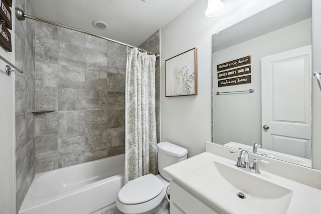 full bathroom with vanity, shower / tub combo with curtain, and toilet