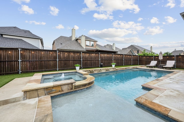 view of swimming pool featuring a patio, a fenced backyard, and a pool with connected hot tub